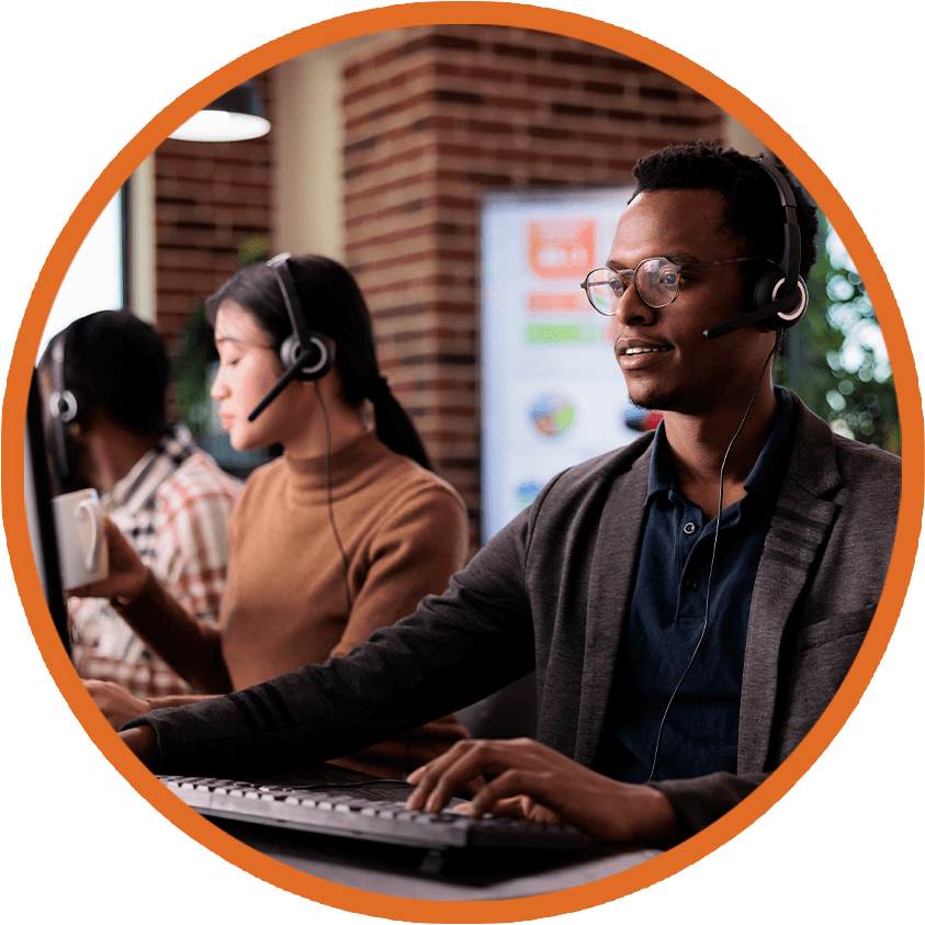 IT helpdesk support team working in an office, wearing headsets and assisting customers online